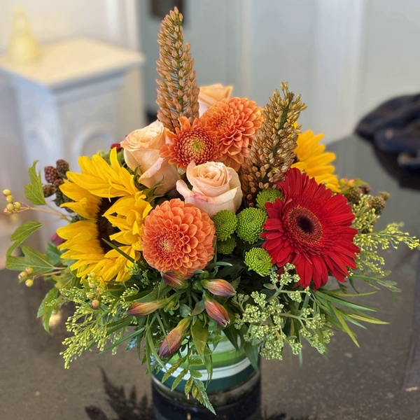 Yellow. orang and red color Thanksgiving flower arrangement